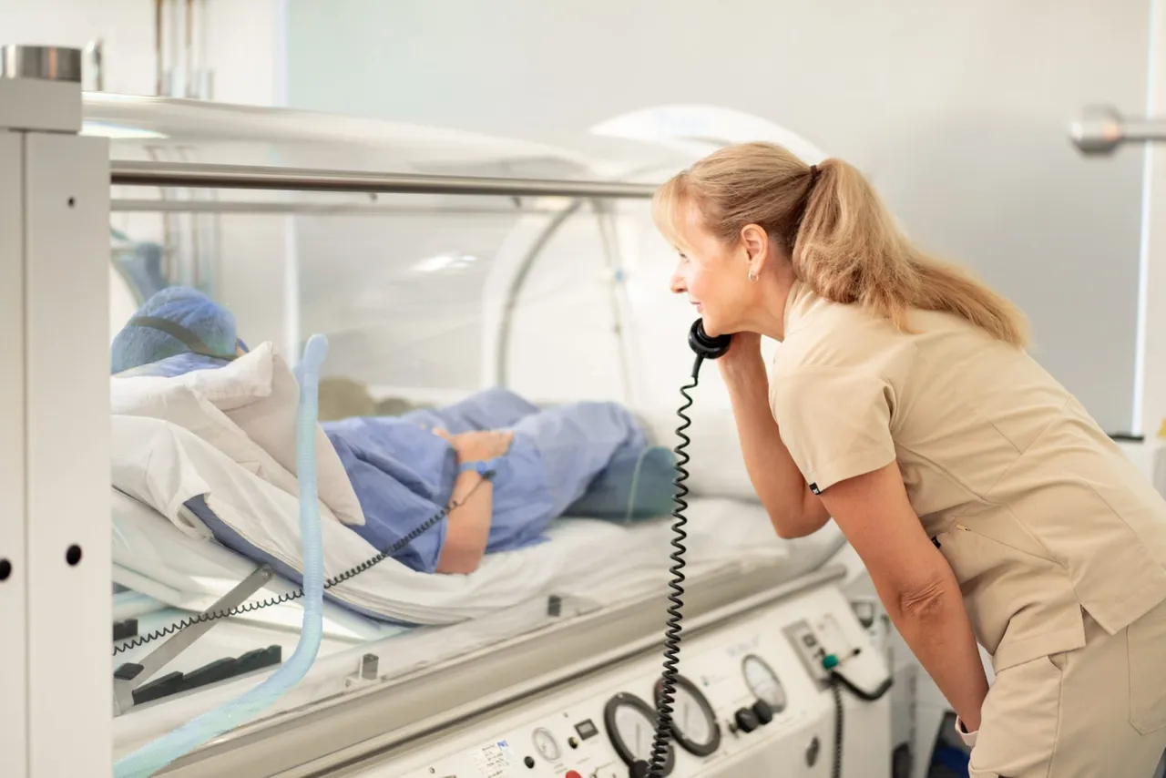 Clinic team member speaking with a patient during a hyperbaric oxygen therapy session