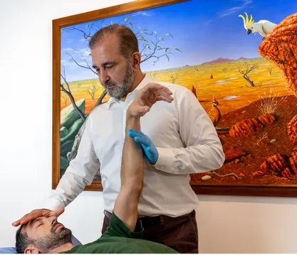 Dr Reza Samvat providing hands-on care at the Gold Coast clinic