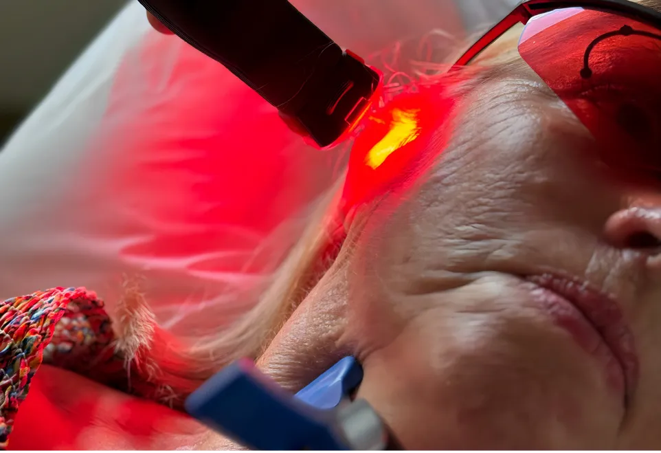 Patient receiving red light (photobiomodulation) therapy