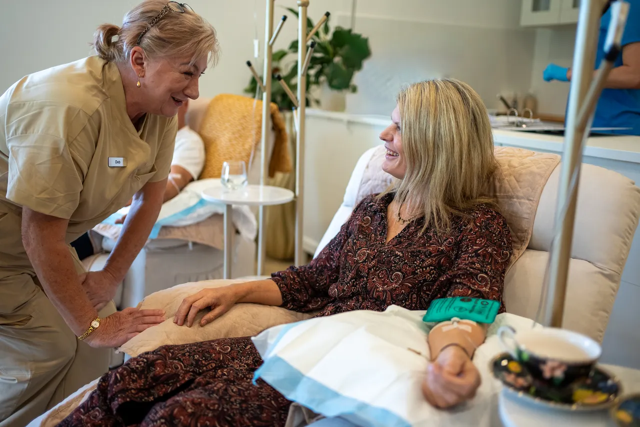 Clinic team member attending to a patient during a vitamin IV therapy session