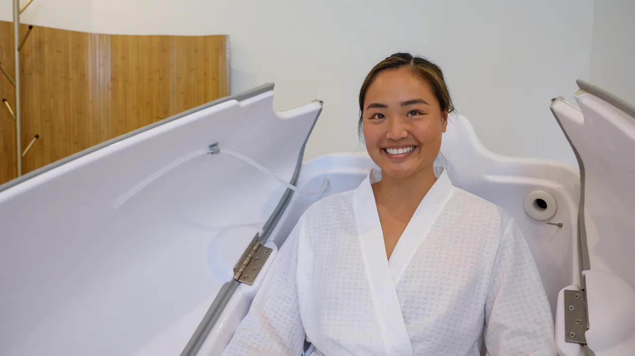Patient seated in the HOCATT active oxygen cabinet at the Gold Coast clinic