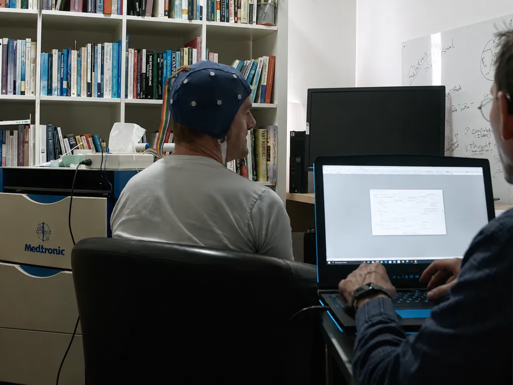 Patient wearing headphones during a qEEG neurotherapy session