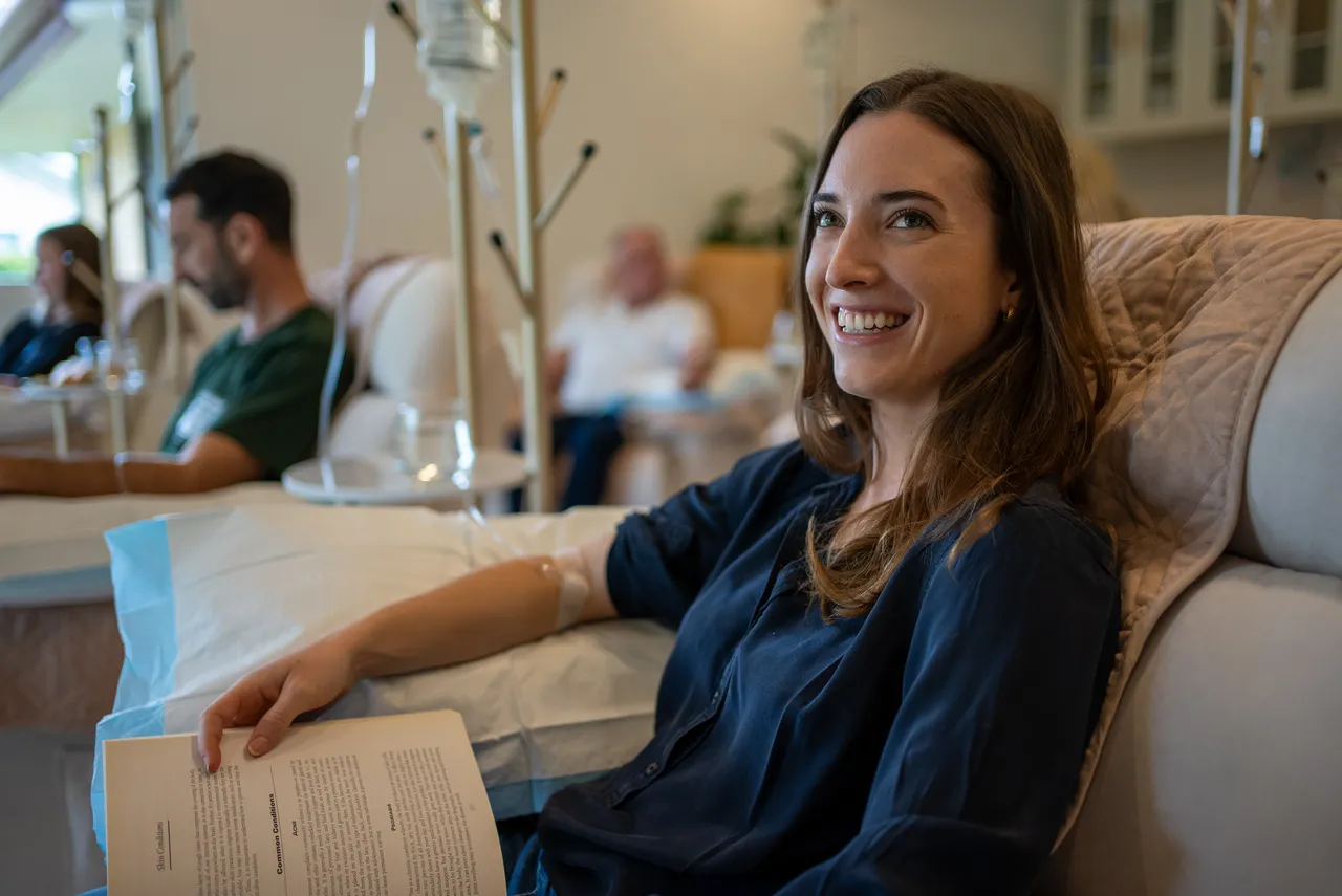Patient reading comfortably during a vitamin IV therapy session